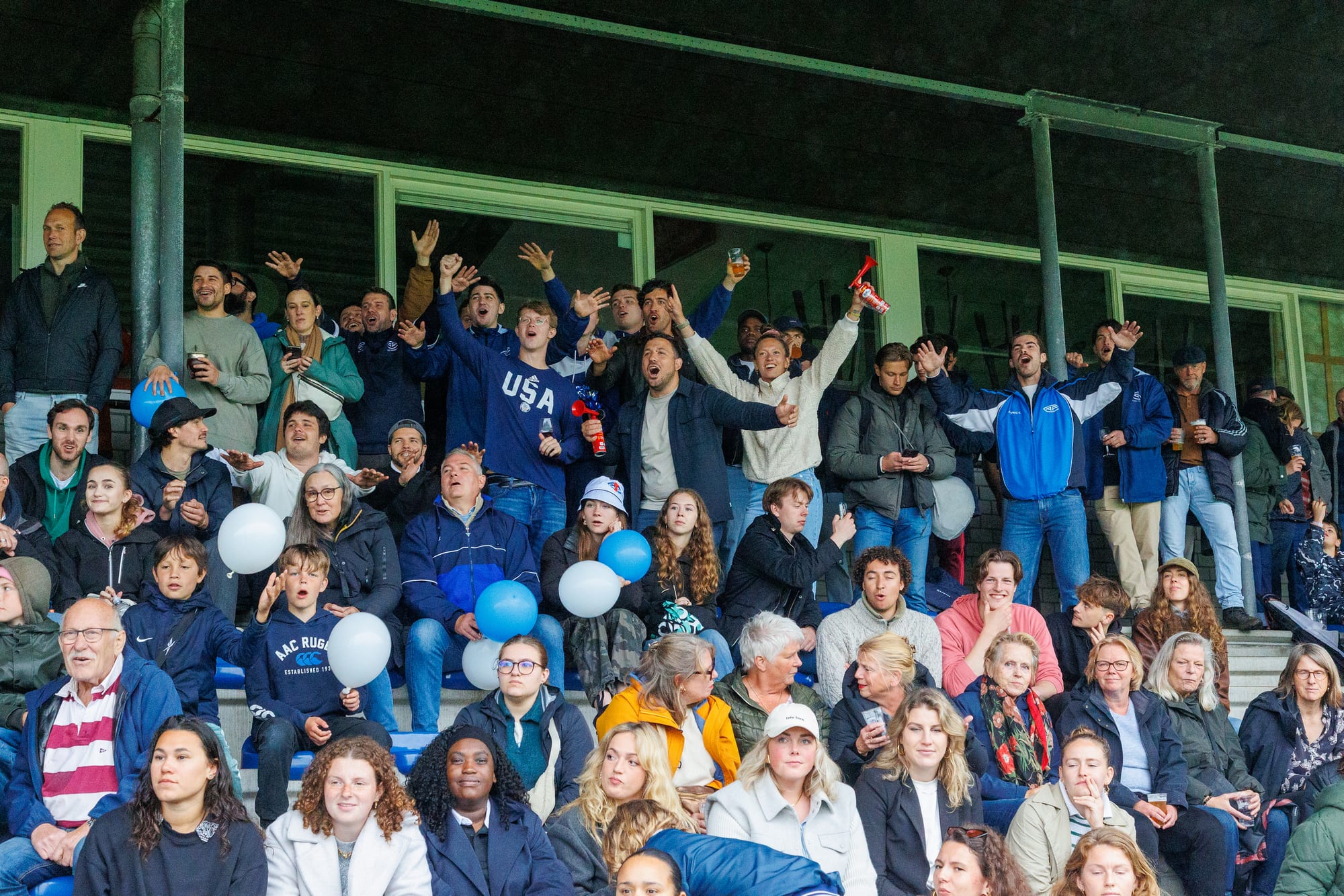 AAC supporters cheer from the stand with club balloons at the women’s Ereklasse final